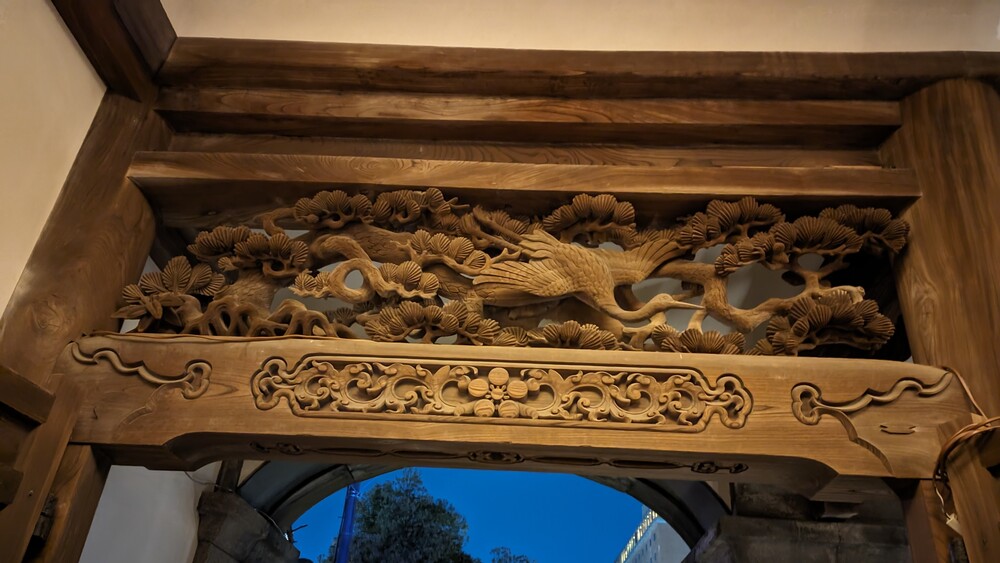 Wooden artwork of a bird and Bonsai