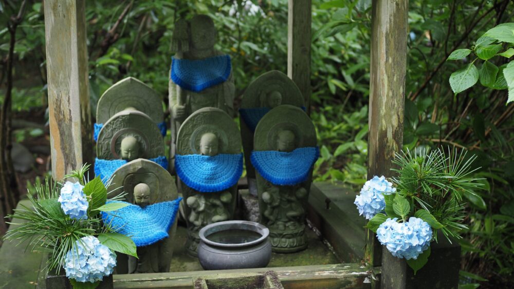 A moody photo of Ojizo-san with blue hydrangea