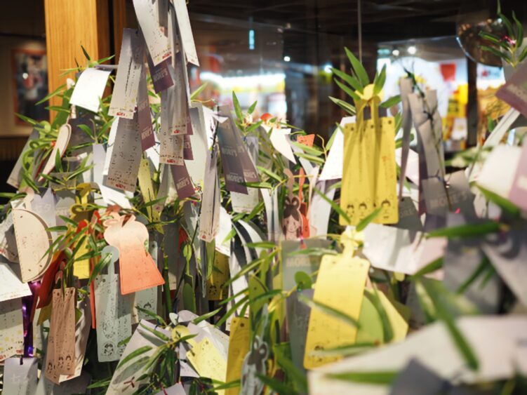 a myriad of Tanzaku papers hang on bamboo decorations